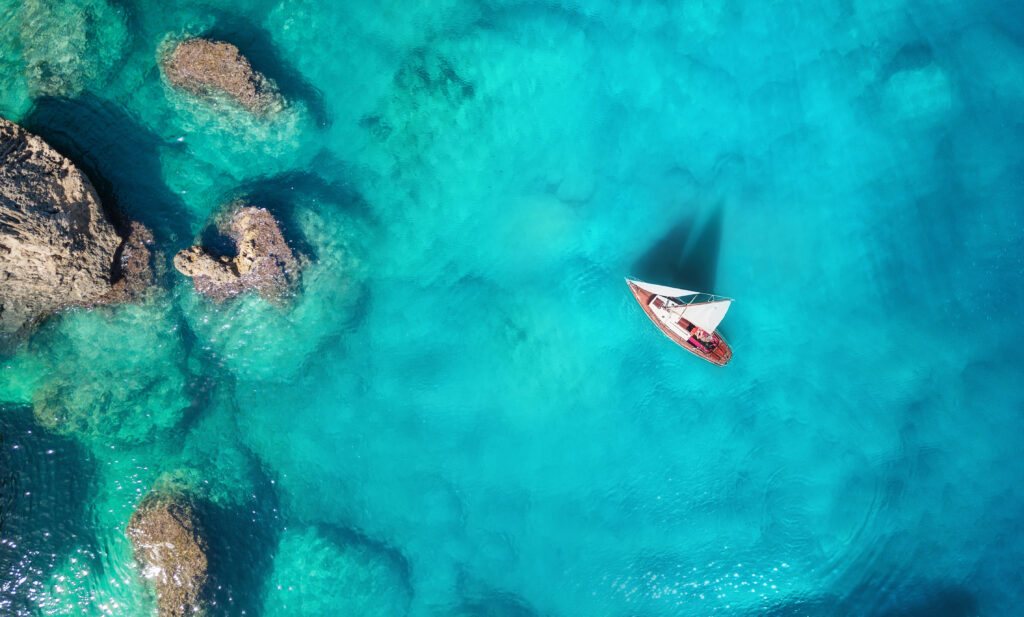 Yacht,On,The,Sea,From,Top,View.,Turquoise,Water,Background